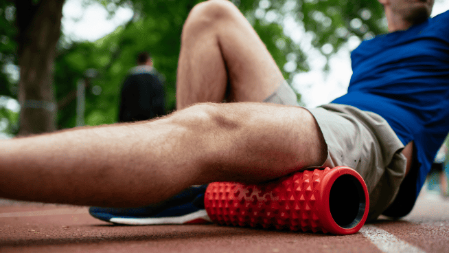 man using foam roller for warm up