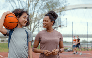 mother talking with her young daughter about basketball and sports